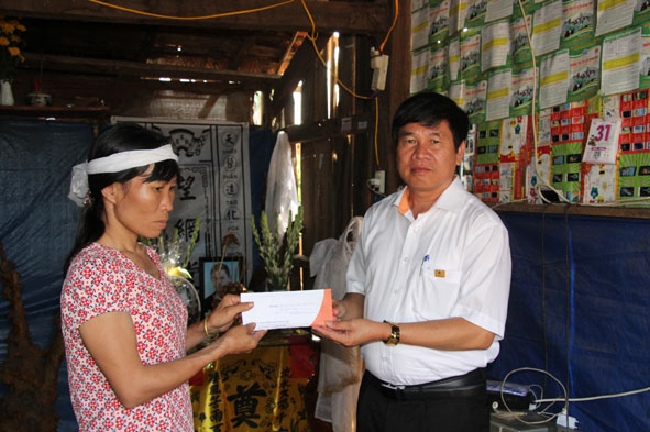 Ông Nguyễn Đạo Quán, Giám đốc Công ty bảo hiểm PJICO Đắk Lắk trao tiền bồi thường cho gia đình chị An