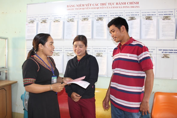 Bà H'Pin Mlô, Chủ tịch UBND xã Pơng Drang trao đổi với người dân đến làm thủ tục hành chính.   