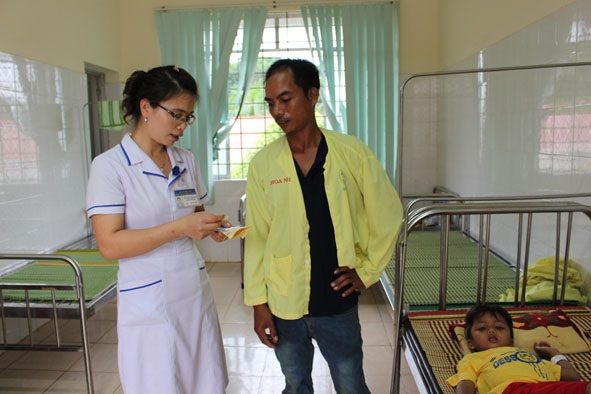 Điều dưỡng Bệnh viện Đa khoa huyện Cư Kuin tư vấn cho người nhà bệnh nhân cách chăm sóc trẻ bị bệnh sởi.