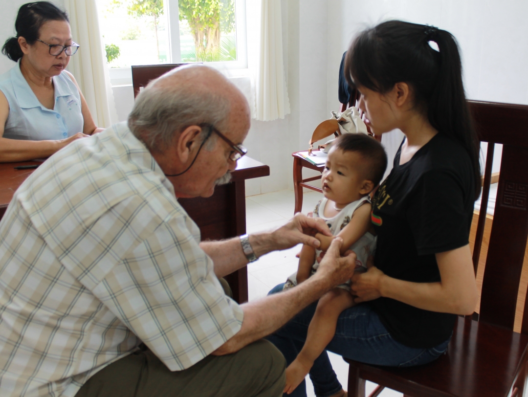 Bác sĩ của Tổ chức phi chính phủ Children Action thăm khám cho trẻ bị dị tật cơ xương khớp.