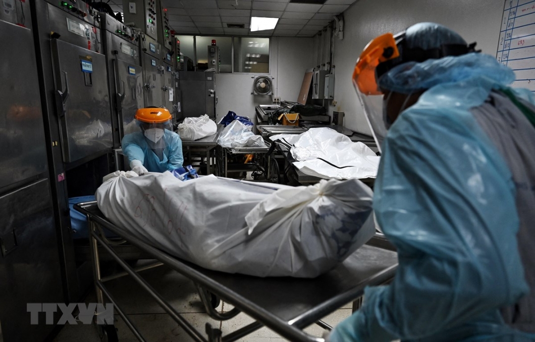 Nhân viên y tế chuyển thi thể bệnh nhân COVID-19 vào nhà xác bệnh viện ở tỉnh Pathum Thani, Thái Lan, ngày 4-8-2021. (Ảnh: AFP/TTXVN)