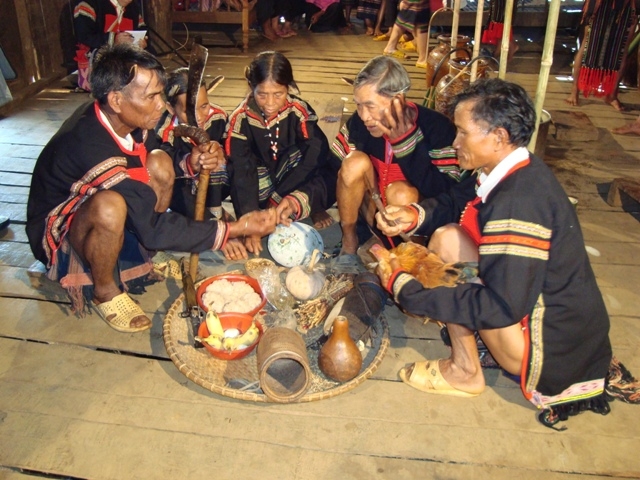 Thầy cúng đang tiến hành nghi lễ Kết nghĩa anh em cho hai cặp vợ chồng. (Ảnh: Hữu Hùng)