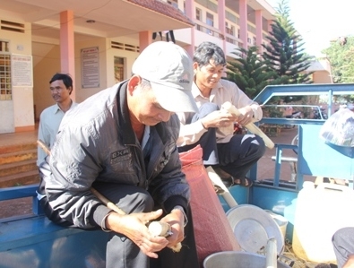 Phụ huynh nhóm dân tộc Êđê đang cắt những ống cơm lam