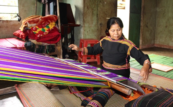 Bà H’Uếc Kpơr bên khung dệt thổ cẩm.    
