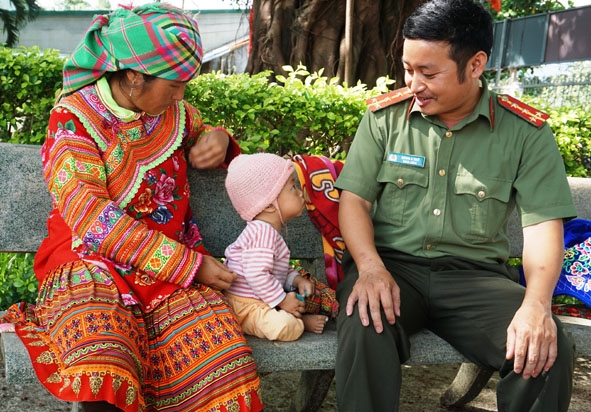 Đại úy Hàng A Trừ ân cần thăm hỏi đồng bào Mông. 