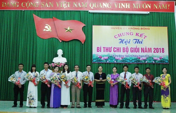 Phó Bí thư Huyện ủy Krông Bông H’Kim Rơ Chăm, Trưởng Ban tổ chức Hội thi tặng hoa các thí sinh tham gia vòng thi chung kết Hội thi. Ảnh: Phan Tuân 