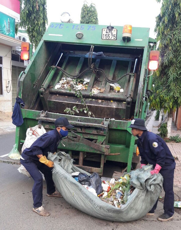 Công nhân Công ty Cổ phần Đô thị và Môi trường Đắk Lắk  thu gom rác thải.