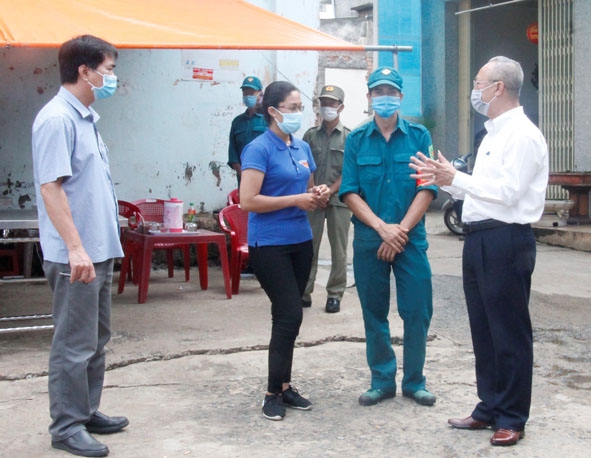 Phó Chủ tịch Thường trực Ủy ban MTTQ Việt Nam tỉnh Lê Xuân Sương (bìa phải) thăm hỏi, động viên lực lượng trực chốt tại khu vực phong tỏa hẻm 13/2/9 đường Nguyễn Văn Cừ. 