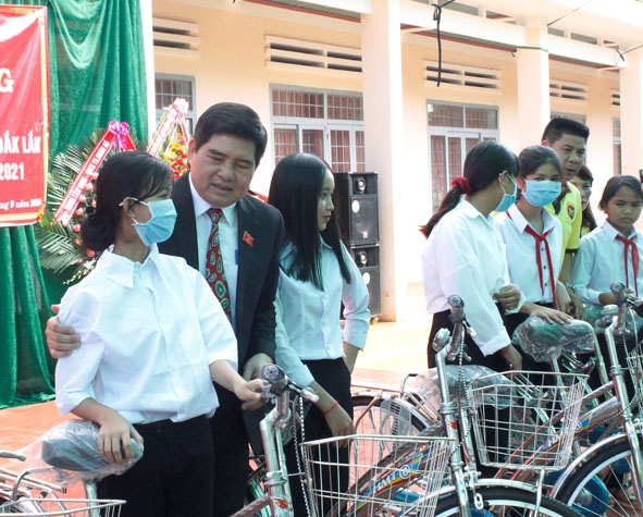 Phó Trưởng đoàn chuyên trách Đoàn đại biểu Quốc hội tỉnh Y Khút Niê động viên các em học sinh nhận xe đạp ở Trường THCS Tô Vĩnh Diện.