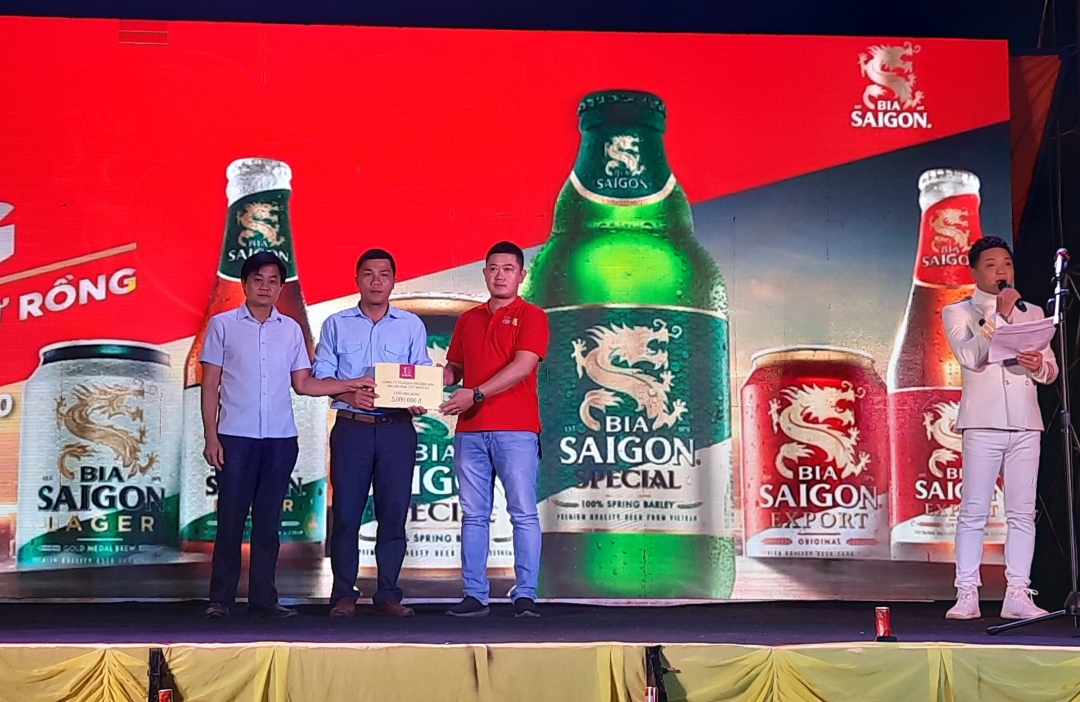 Đại diện Công ty Cổ phần Thương mại Bia Sài Gòn Tây Nguyên trao học bổng cho học sinh nghèo