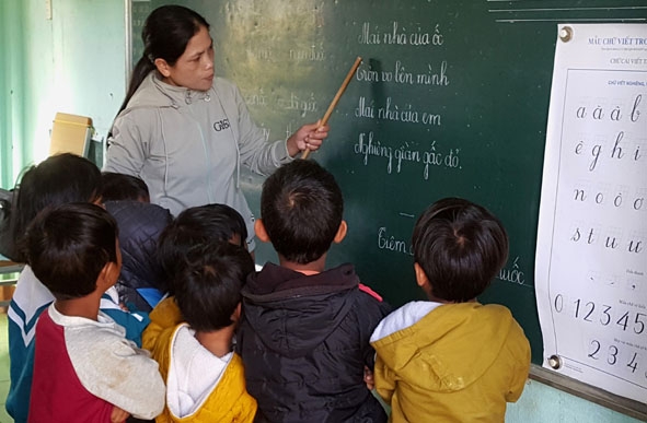 Tranh thủ giờ nghỉ, cô H'Jen phụ đạo thêm cho những học sinh học yếu của lớp.   