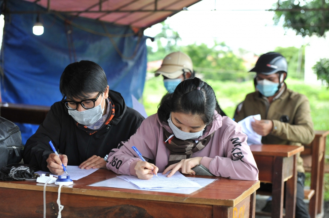 Người dân từ TP. Hồ Chí Minh về tỉnh thực hiện khai báo y tế tại Chốt kiểm soát dịch trên Quốc lộ 14 (